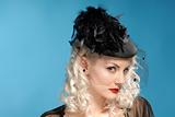 gorgeous retro girl in forties hat with feathers