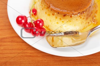Cream caramel dessert with red currants