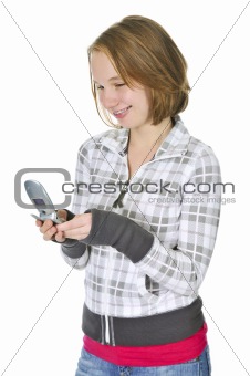Teenage girl text messaging on a cell phone