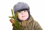 boy in winter coat with a branch of fur tree
