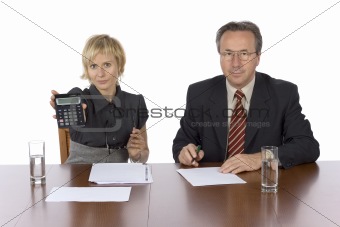 business meeting - woman displays calculator