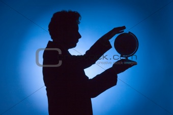 silhouette of man with globe