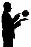 silhouette of man with globe - pointing