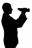 silhouette of man with binoculars