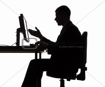 silhouette of man working computer