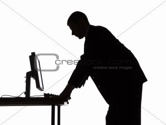 silhouette of man at the computer