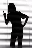 silhouette of woman threatens by finger