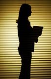 silhouette of woman with papers