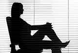 silhouette of woman sitting in the office (blind)