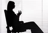 silhouette of woman sitting in the office (blind)