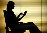 silhouette of sitting woman with calculator (blind)