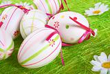 Closeup of several Easter eggs over green artifial grass.