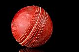 Red Cricket ball on black background