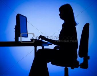 silhouette of woman working computer