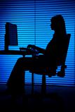 silhouette of woman working computer (blind)
