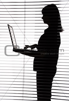 silhouette of woman with laptop