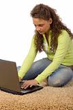 female teenager on the carpet with laptop