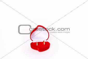 Wedding rings in red heart shaped velvet box 