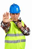 Construction worker talking with a walkie talkie and orders to s