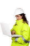Female construction worker write in a laptop