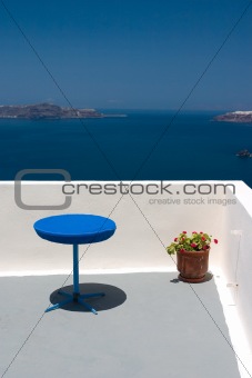 Balcony with blue table and red plant