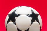 White soccer ball on a red background