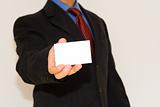 business man holding a white card