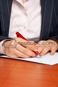 Business woman writing a contract