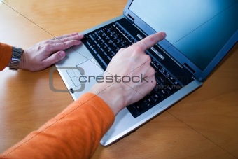 Young pointing to laptop