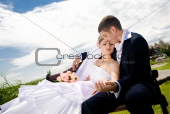 bride and groom on the bench