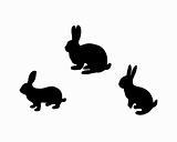 Black silhouette of three bunnys on white