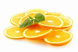 The slices of an orange decorated with lemon mint. 