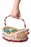 Holding basket full of easter eggs