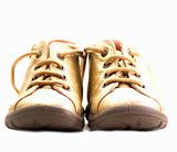 Cute golden baby shoes isolated on white