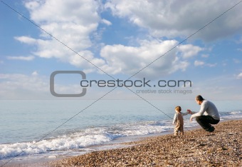 father and son on pebble beach