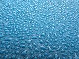 Water drops over blue plastic material