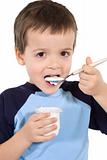 Little kid eating yoghurt