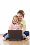 Woman and little girl at the laptop