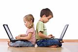 Siblings using laptops
