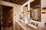 Luxurious Rustic Bathroom with Mining Lamps in Spa Setting.