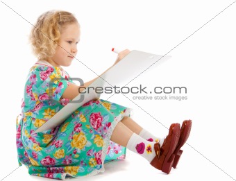 Preschooler sits drawing