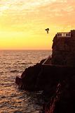 Cliff diver off the coast of Mazatlan at sunset