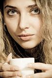 Close-up portrait of beautiful woman drinking coffee