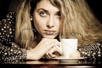 Close-up portrait of beautiful young woman drinking coffee