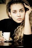 Portrait of beautiful young woman holding a cup of coffee