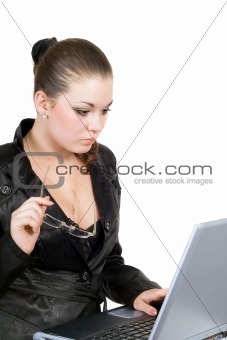 Young businesswoman works on the laptop. Isolated