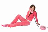 Young beautiful woman in the pink sportswear talking on phone