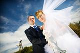 bride with flying veil and groom