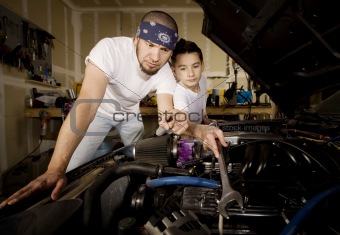 Hispanic father and son in garage