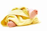 tiny baby's feet in towel over white